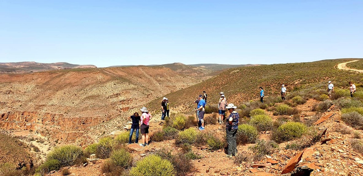 Guests exploring a broad Namaqualand landscape