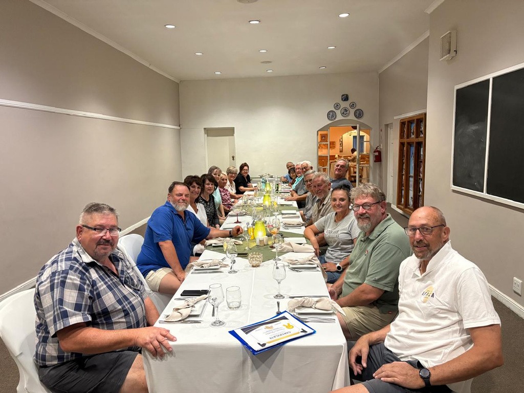 Guests sharing a hosted meal during a Why Not Africa Tours journey