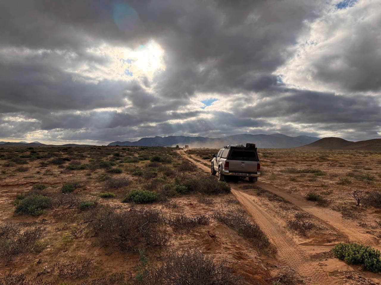 Guided 4x4 convoy travelling through a remote South African mountain landscape
